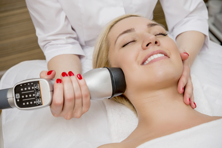 Female taking a facial massage in the spa salonの写真素材