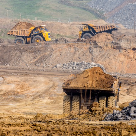 Big yellow mining truck ground moving in open pit