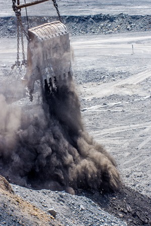 dredge ladle at open pit droping rocksの写真素材