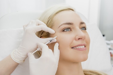 Beautiful woman gets beauty facial injections. Face aging injection. Aesthetic Cosmetologyの写真素材