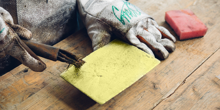 Raw gold ingot in hands just made at a factoryの写真素材