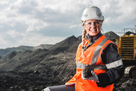 Young beautiful female holding a piece of coalの写真素材