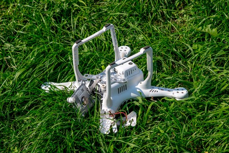 Crashed quadcopter after an accident laying on the groundの写真素材