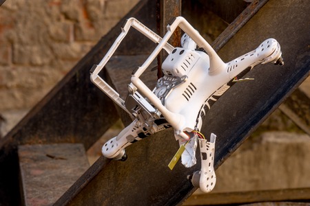 Crashed quadcopter after an accident that stuck on the ladderの写真素材