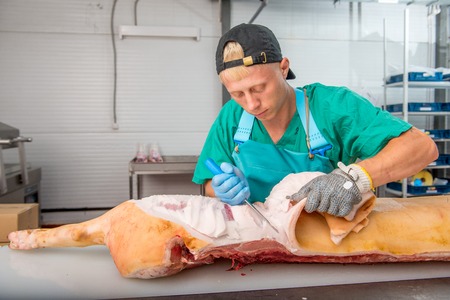 Russia - July, 2016: Young man working at a meat factoryのeditorial素材