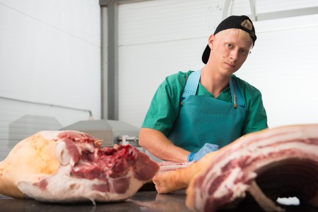 Russia - July, 2016: Young man working at a meat factoryのeditorial素材