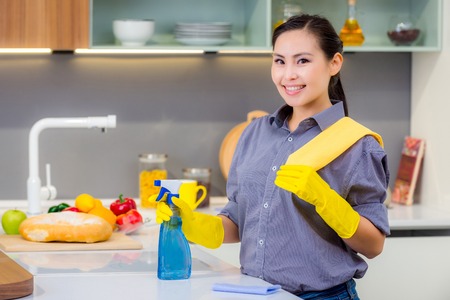 Young beautiful asian woman housekeeping in the kitchenの写真素材