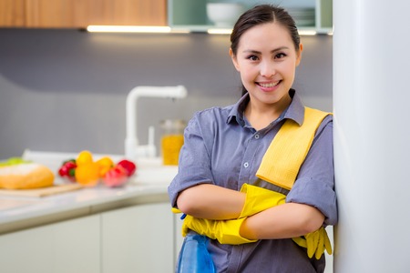 Young beautiful asian woman housekeeping in the kitchenの写真素材