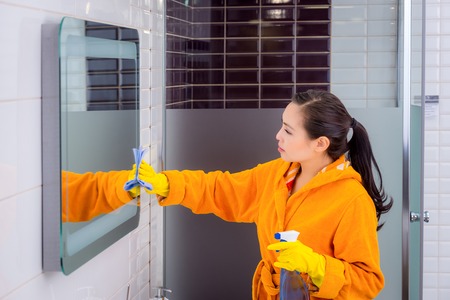 Young beautiful asian woman housekeeping in the bathroom