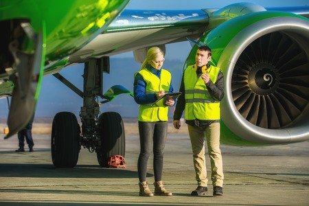 airport staff workers preapre the airplane for flight