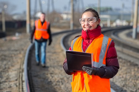 Man and a woman railroad workers maintaing railwayの写真素材