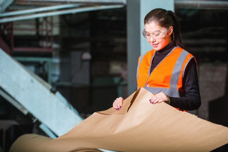 Paper mill factory worker checking paper qualityの写真素材