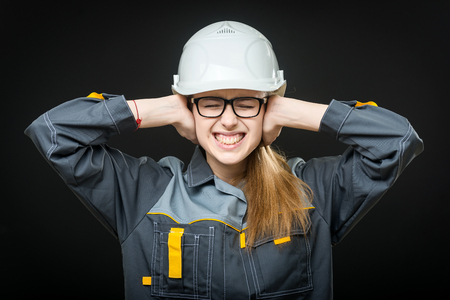 portrait of a young female worker on the black backgroundの写真素材