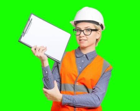 Isolated female worker portrait on the green backgroundの写真素材