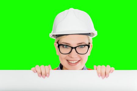 Isolated female worker portrait on the green backgroundの写真素材