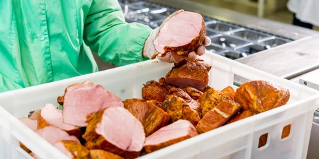 raw meat at a factory in a basket before conveyour