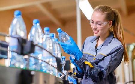 Specialist in factory checking bottlesの写真素材