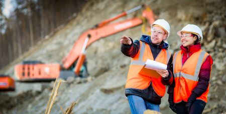 Road workers inspecting construction