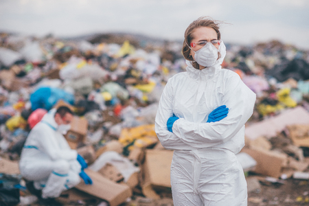 Recycling workers researching on the landfill