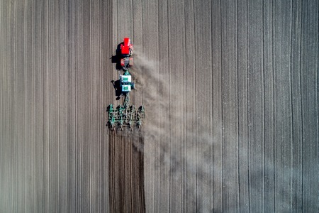 tractor sowing in the field. earial view.の写真素材