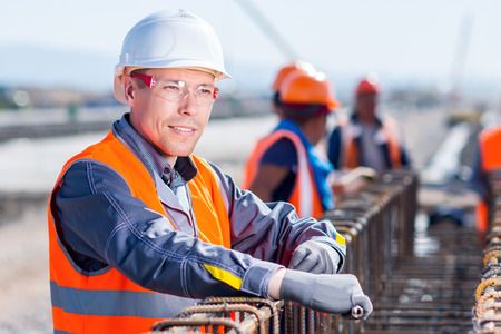 Worker fixing steel re bar at building siteの写真素材