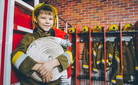 A child in firefighter's uniform playing