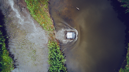 An off-road vehicle sails on the river. aerial above view topの写真素材