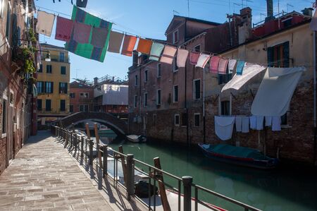 Clothes line crossing over a channel in Venezia. Authentic venezian viewの写真素材