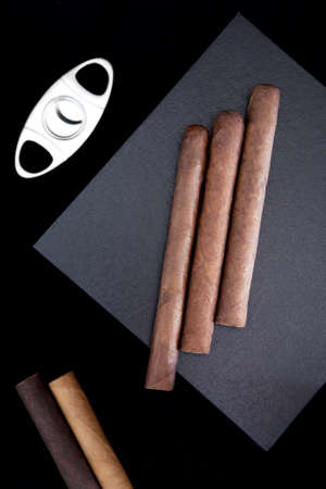 three cigars on the box and cutter on dark backgroundの写真素材