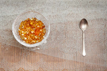 Yellow amber in a crystal vase on the tableの写真素材