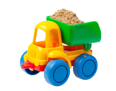 Colorful toy truck with sand isolated over white backgroundの写真素材