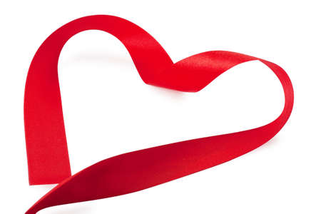 Red heart-shaped silk ribbon over white backgroundの写真素材