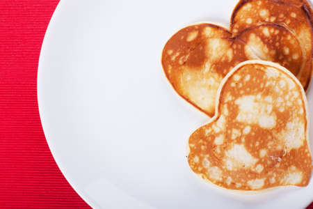 Two heart-shaped pancakes on a plateの写真素材