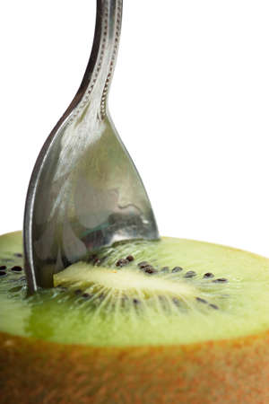 Closeup view of teaspoon in a kiwi fruitの写真素材