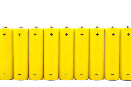 A row of yellow batteries isolated over white backgroundの写真素材