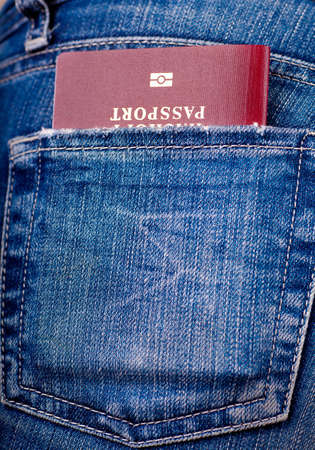 Closeup view of a denum pocket with a passportの写真素材