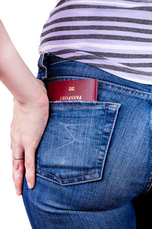 Passport in a pocket of woman jeansの写真素材