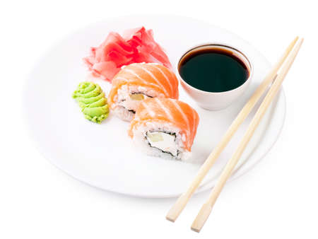 Sushi, soy and ginger with chopsticks on a white plateの写真素材