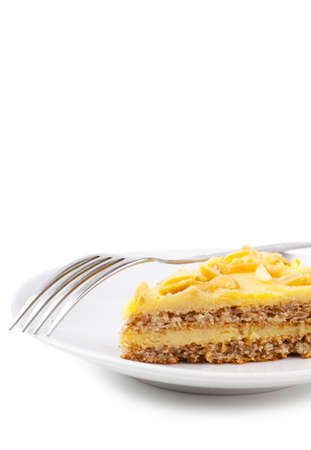 Closeup view of piece of sweet pie and fork on a white plateの写真素材