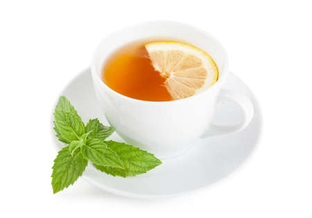 Tea with piece of lemon and mint on a plate over white backgroundの写真素材