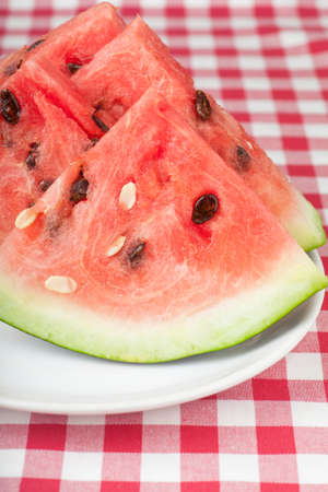 Fresh watermelon slices on a white plateの写真素材