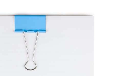 Macro view of blue paper clip on a blank sheets of paperの写真素材