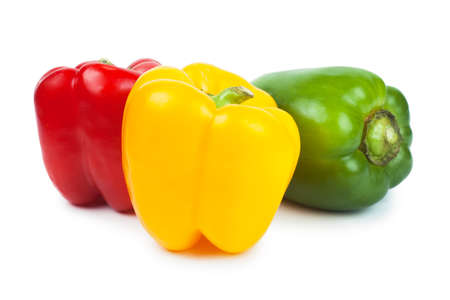 Three sweet peppers red, green and yellow over white backgroundの写真素材