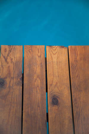 Closeup view of wooden pier with blue sea backdropの写真素材