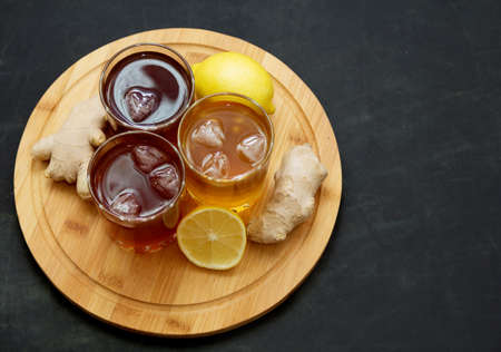 Kombucha. drinks of different colours and textures in glass cups on table on black background. A place for a label. Copyspaceの写真素材