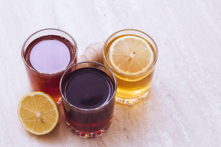 drinks of different colours and textures in glass cups on table on  light background. A place for a label. Copyspaceの写真素材