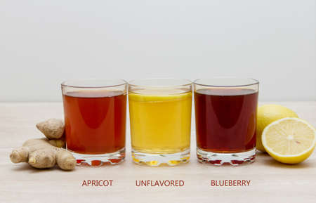 Kombucha. drinks of different colours and textures in glass cups on table. A place for a label. Copyspaceの写真素材