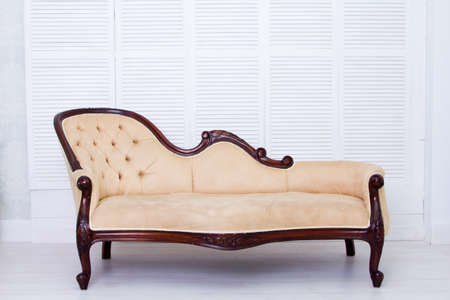 Beige textile classical style sofa in vintage room.の写真素材