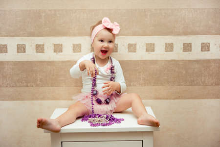 Beautiful little happy girl with a pink bowの写真素材