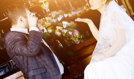 Husband takes his wife to the wedding, and she sends him a kissの写真素材